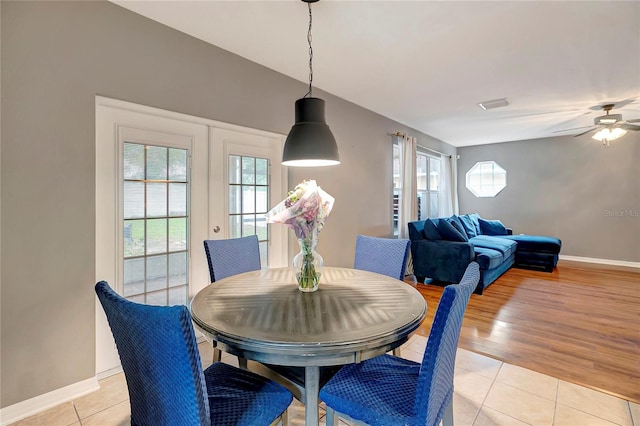 dining room with baseboards, light tile patterned flooring, ceiling fan, and french doors