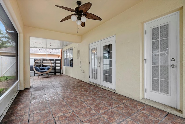 sunroom with french doors and a ceiling fan