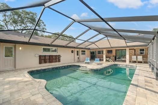 5216 Hope Ln, Spring Hill, FL 34606 - outdoor pool with a patio and glass enclosure