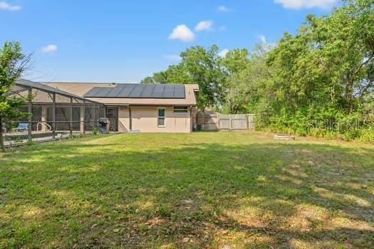 5216 Hope Ln, Spring Hill, FL 34606 - rear view of house featuring solar panels and glass enclosure