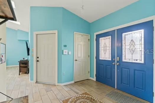 5216 Hope Ln, Spring Hill, FL 34606 - entrance foyer featuring baseboards, light wood-style floors, and french doors