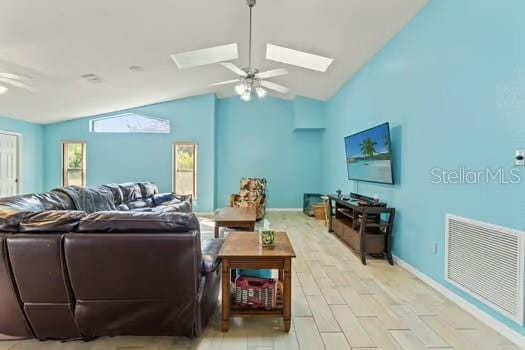 5216 Hope Ln, Spring Hill, FL 34606 - living area featuring lofted ceiling, ceiling fan, a skylight, and baseboards