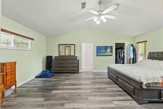 5216 Hope Ln, Spring Hill, FL 34606 - bedroom featuring baseboards, wood finished floors, lofted ceiling, and a ceiling fan