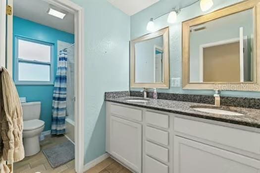 5216 Hope Ln, Spring Hill, FL 34606 - bathroom with toilet, double vanity, and shower / bath combo