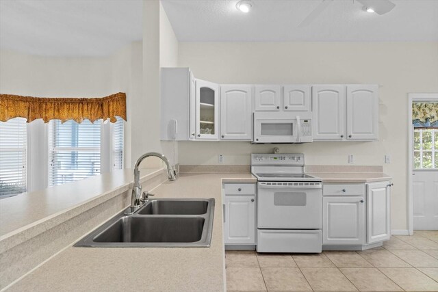6240 W Glynborne Loop, Crystal River, FL 34429 - kitchen with white appliances, a sink, white cabinetry, and light tile patterned floors