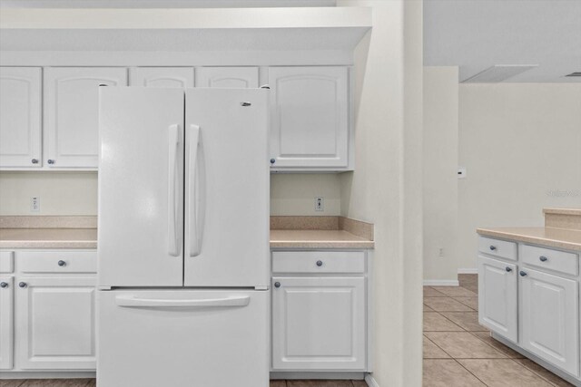 6240 W Glynborne Loop, Crystal River, FL 34429 - kitchen featuring freestanding refrigerator, white cabinets, light tile patterned floors, and light countertops
