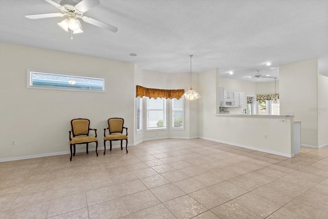 6240 W Glynborne Loop, Crystal River, FL 34429 - living area with a ceiling fan, light tile patterned floors, and baseboards