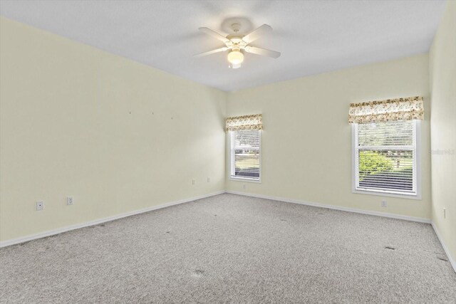 6240 W Glynborne Loop, Crystal River, FL 34429 - empty room featuring carpet flooring, plenty of natural light, a ceiling fan, and baseboards
