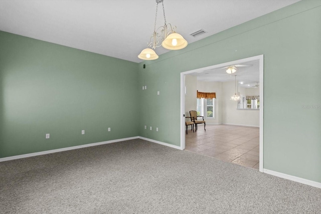 6240 W Glynborne Loop, Crystal River, FL 34429 - empty room with carpet flooring, baseboards, tile patterned flooring, and a chandelier