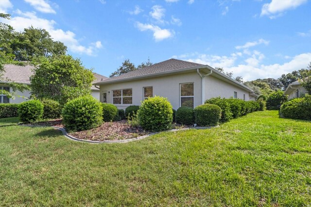 6240 W Glynborne Loop, Crystal River, FL 34429 - view of side of property featuring stucco siding and a yard
