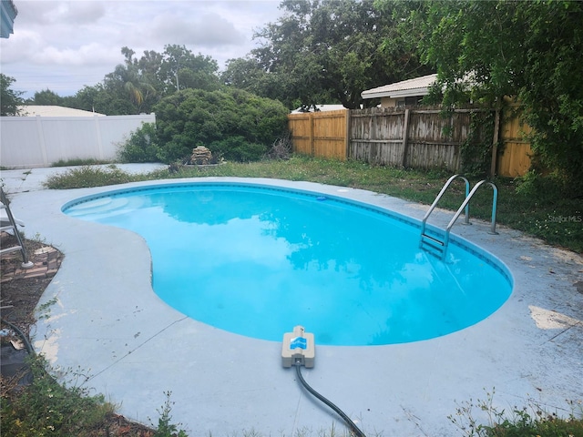 view of swimming pool featuring a fenced backyard