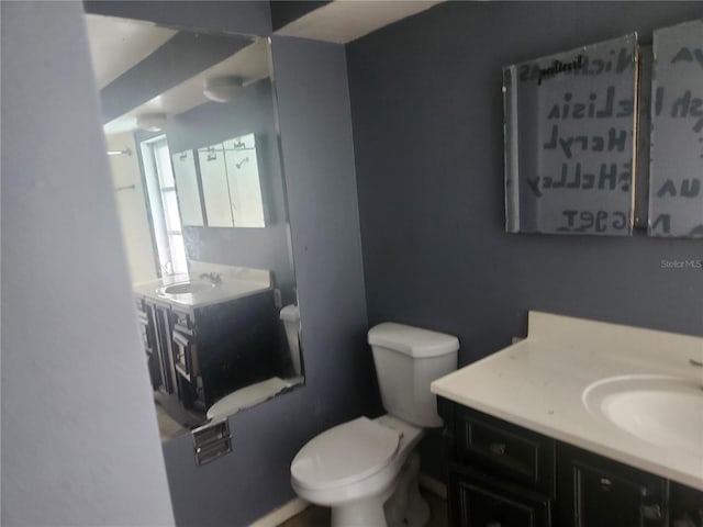 bathroom featuring toilet and vanity
