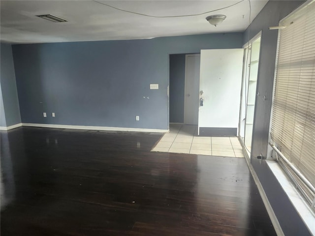 empty room with wood finished floors and baseboards