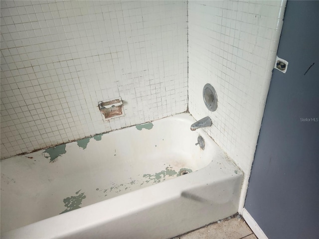 bathroom view of a tub and baseboards