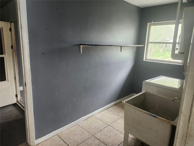 washroom featuring washer / clothes dryer, tile patterned floors, and baseboards