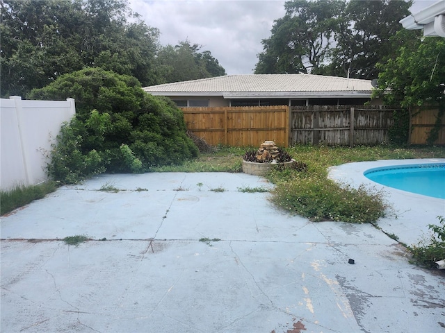 view of swimming pool featuring a patio and a fenced backyard