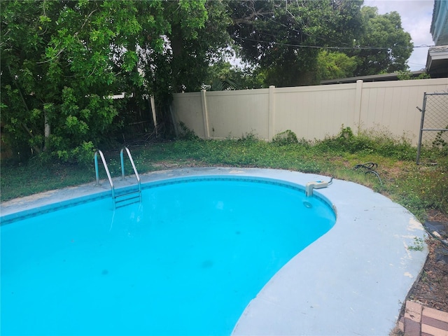 view of pool featuring fence