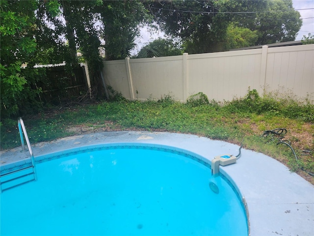view of pool featuring fence