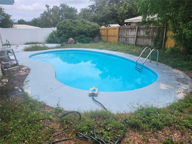 view of swimming pool featuring a fenced backyard
