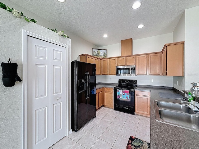 kitchen with black appliances, a sink, light tile patterned floors, a textured ceiling, and recessed lighting