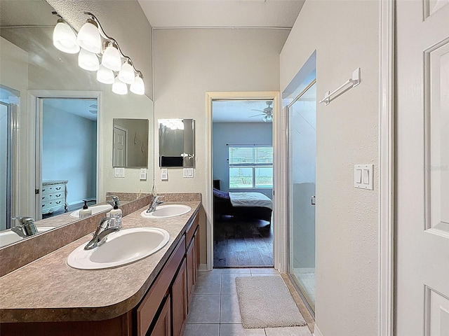 full bathroom with tile patterned floors, connected bathroom, a stall shower, double vanity, and a ceiling fan