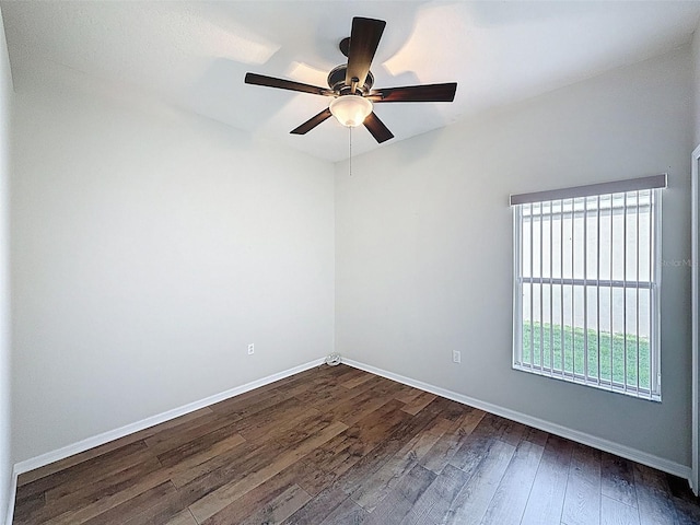 unfurnished room with dark wood-style flooring, baseboards, and ceiling fan