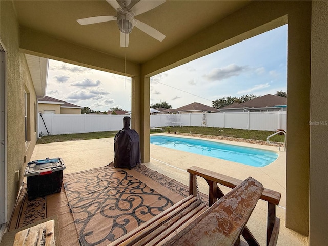 view of pool with a patio area, ceiling fan, and a fenced backyard