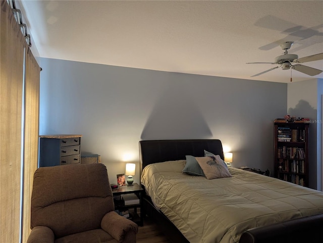bedroom with wood finished floors and a ceiling fan