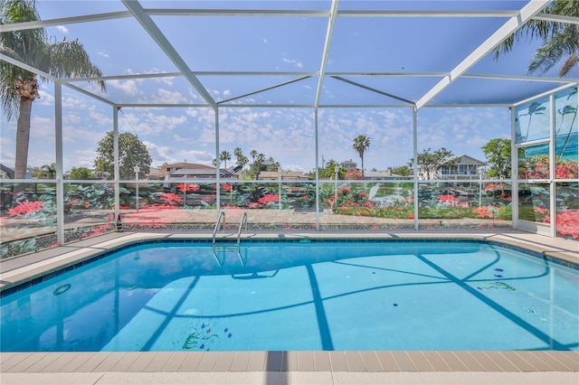 swimming pool featuring glass enclosure and a patio