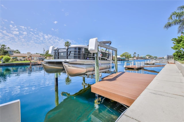 dock featuring boat lift and a water view
