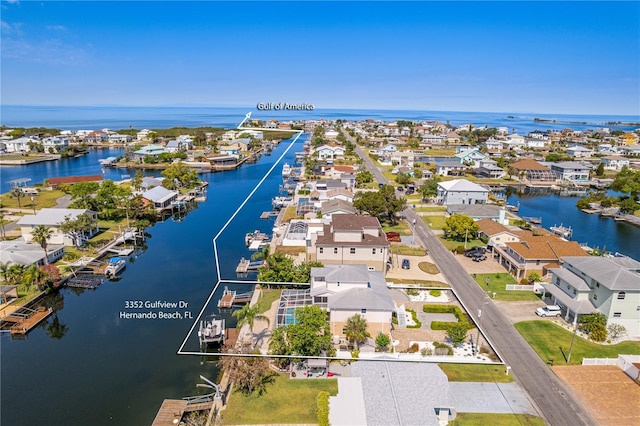 aerial view of residential area featuring a nearby body of water