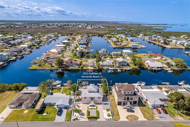 aerial view of residential area with a large body of water