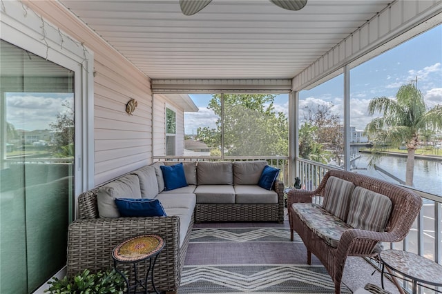 sunroom / solarium with an outdoor living space, plenty of natural light, and a water view