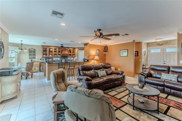 living room with a ceiling fan, light tile patterned floors, ornamental molding, and recessed lighting