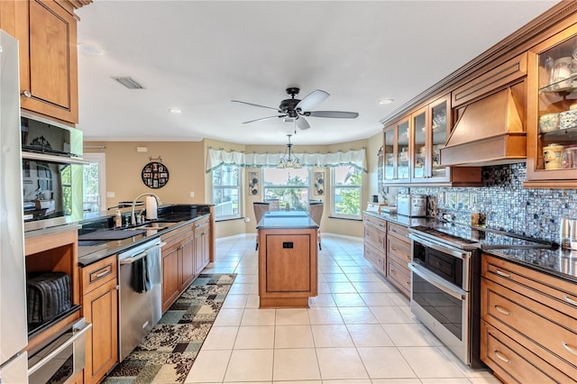 kitchen with stainless steel appliances, custom exhaust hood, plenty of natural light, decorative backsplash, and recessed lighting