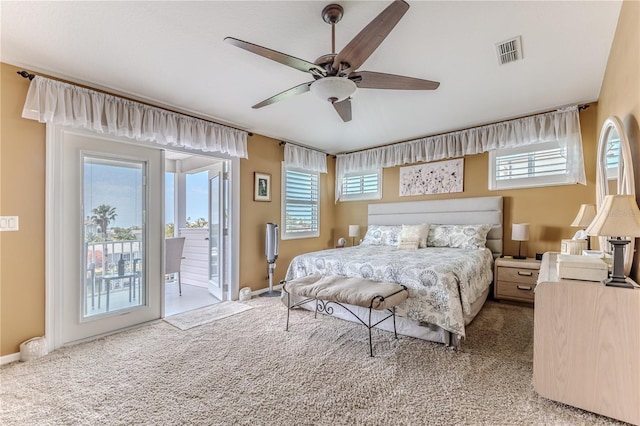 carpeted bedroom featuring access to exterior, multiple windows, baseboards, and ceiling fan