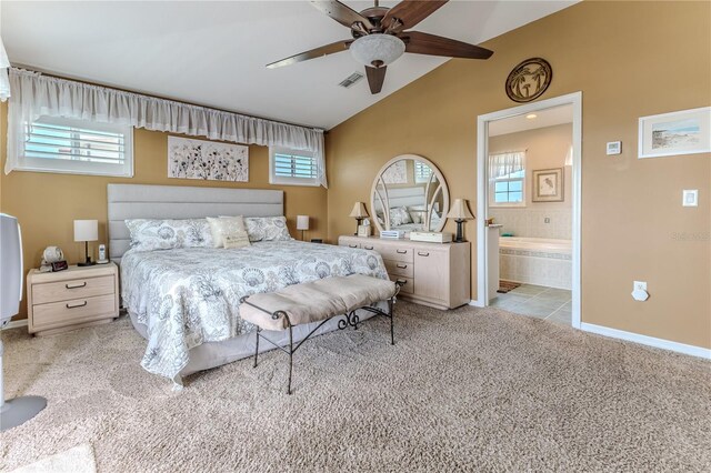 carpeted bedroom featuring vaulted ceiling, baseboards, ceiling fan, and ensuite bathroom