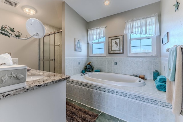 bathroom with a shower stall, tile patterned flooring, vanity, and a garden tub