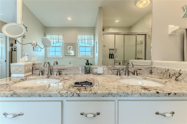 full bath featuring a shower stall and double vanity