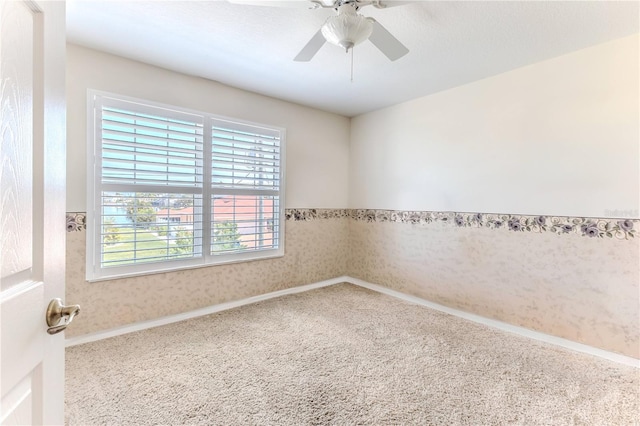carpeted empty room featuring ceiling fan