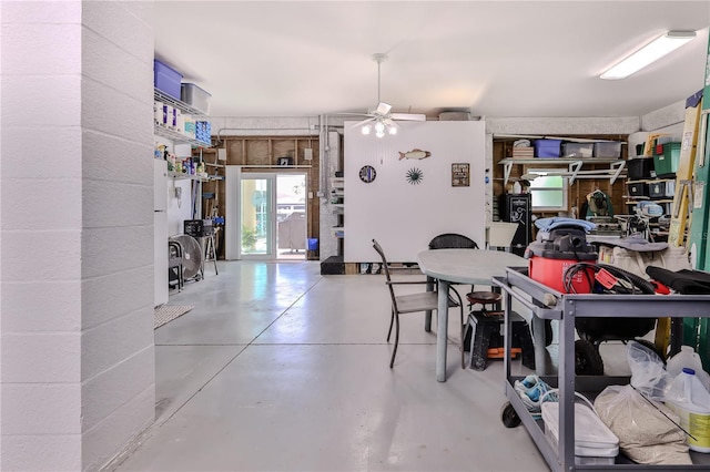 dining space featuring concrete flooring and ceiling fan