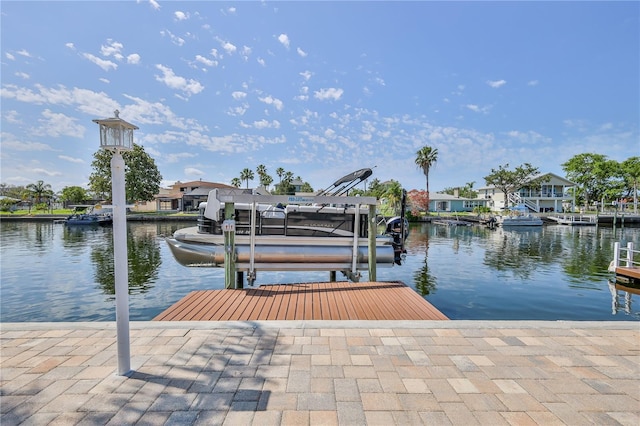 dock area with a water view and boat lift