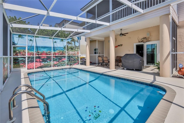 swimming pool featuring a patio, a ceiling fan, a lanai, and outdoor dining space
