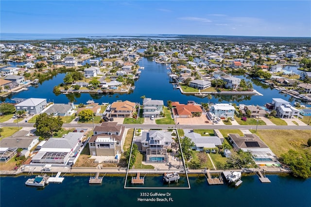aerial perspective of suburban area with a nearby body of water