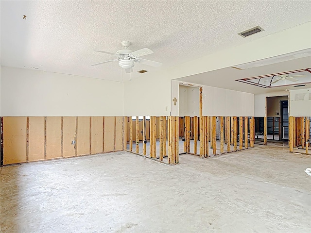4420 Marine Pkwy, New Port Richey, FL 34652 - unfurnished room with a textured ceiling, ceiling fan, and concrete flooring