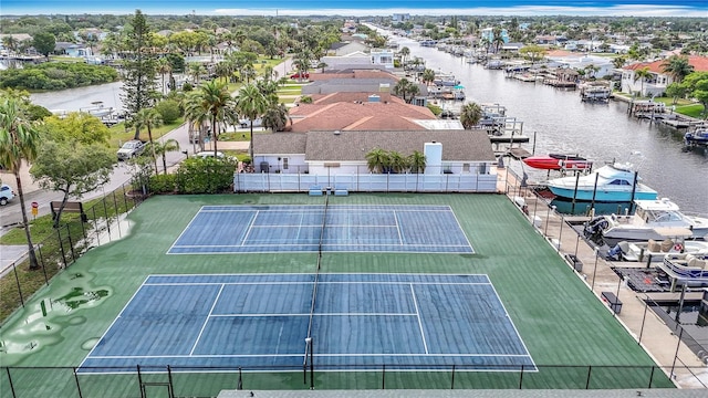 4420 Marine Pkwy, New Port Richey, FL 34652 - view of tennis court featuring fence, a water view, and a residential view