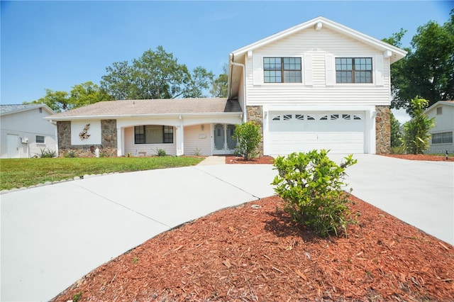 12106 Bear Creek Ln, Hudson, FL 34667 - traditional-style home featuring stone siding, concrete driveway, an attached garage, and a front yard