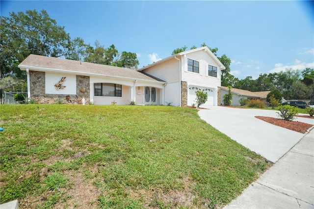 12106 Bear Creek Ln, Hudson, FL 34667 - view of front of home with stone siding, an attached garage, driveway, and a front lawn