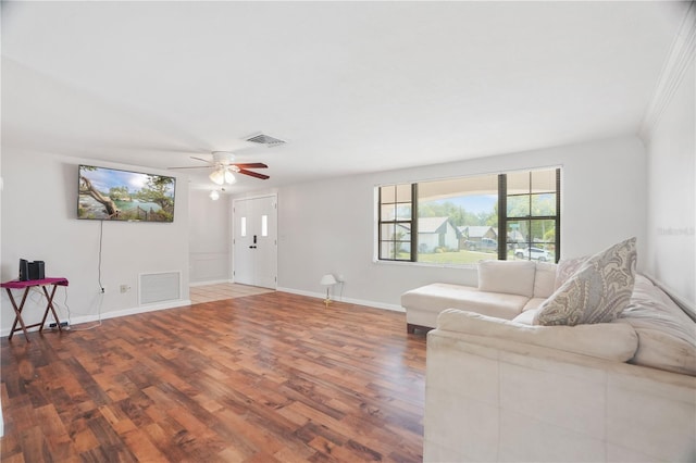 12106 Bear Creek Ln, Hudson, FL 34667 - living room with wood finished floors, baseboards, and ceiling fan