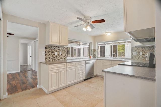 12106 Bear Creek Ln, Hudson, FL 34667 - kitchen with dishwasher, a ceiling fan, tasteful backsplash, and a textured ceiling